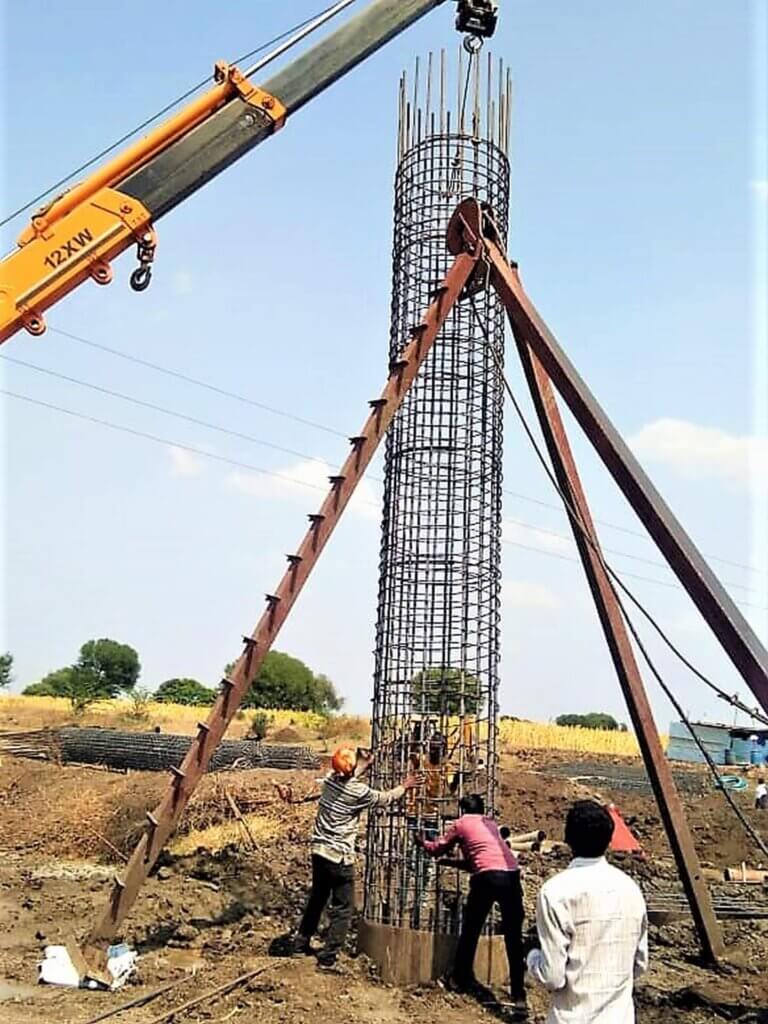 Installation of steel cage into the dug holes.