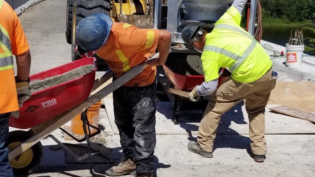 Filling pockets of precast bridge deck panel with DURA.