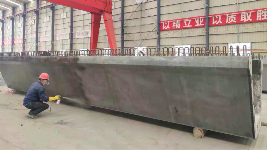 Spraying a layer of coating.