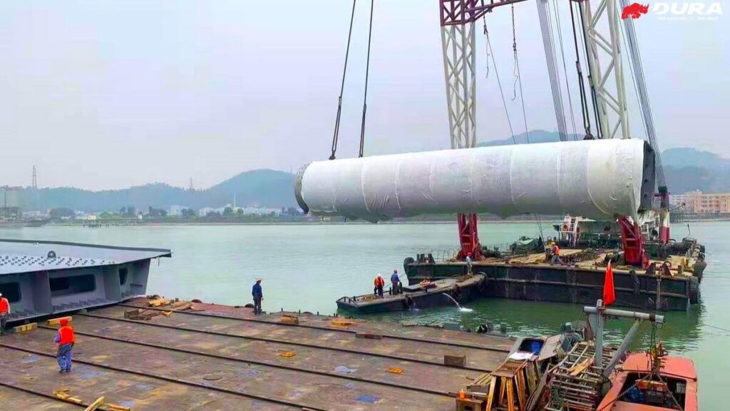 Transportation of UHPFRC composite arch leg to barge.