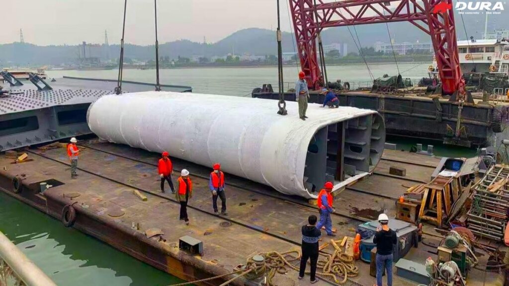 Transportation of UHPFRC composite arch leg to barge.