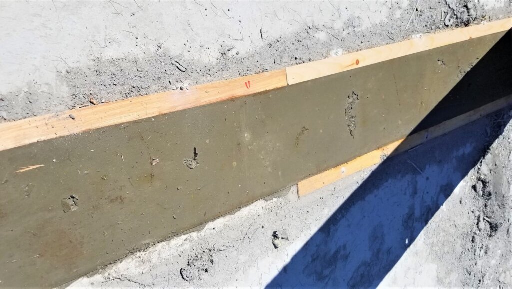 Removal of timber formwork after 1 day.