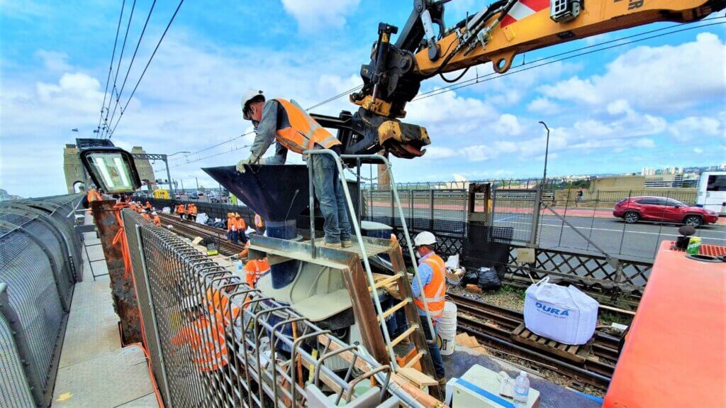Contractor inspecting the mixing of the UHPC.