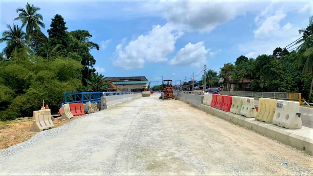 Compaction of crusher run material at the approach road.