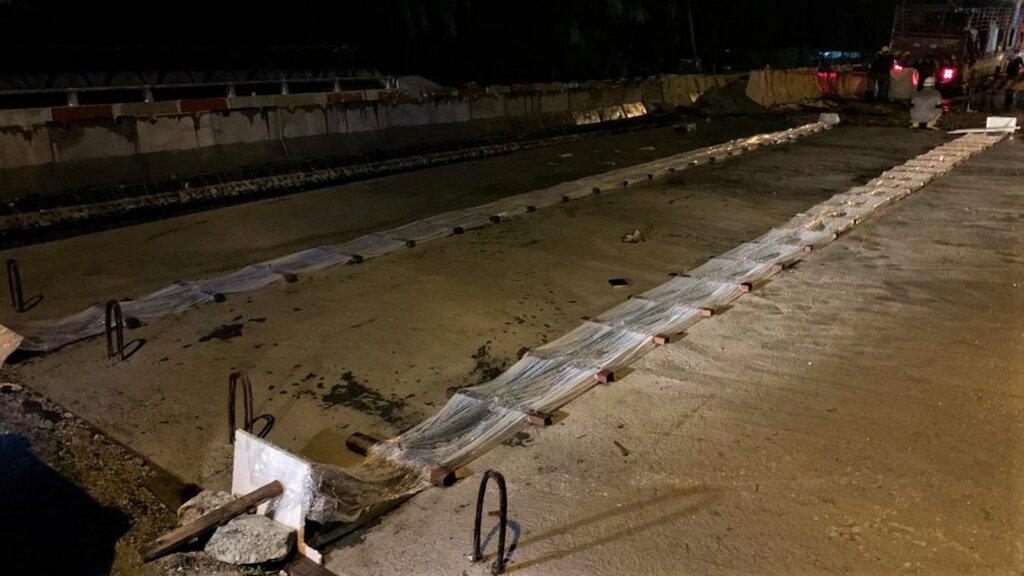 Curing of UHPC in-filled stitches.