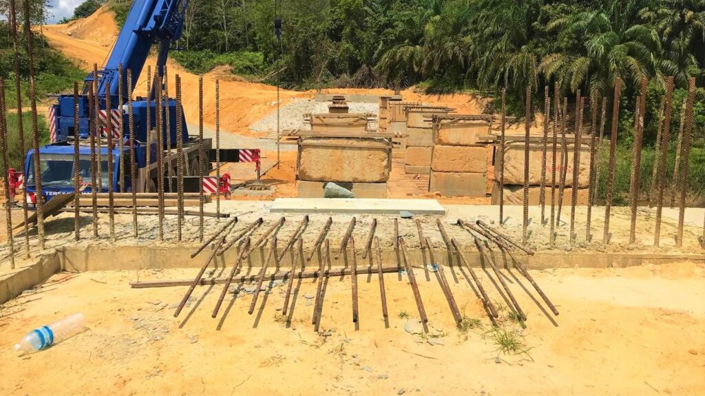 Platform preparation for beam assembly using concrete block as temporary supports.