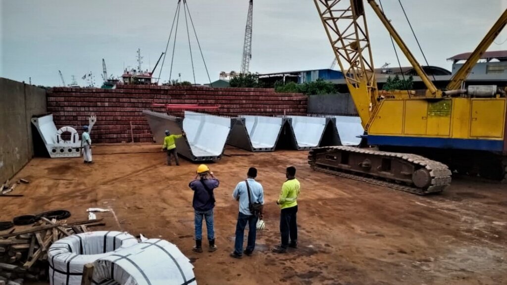 Positioning U beam segments on the storage space of the ship, which is going to Sabah.