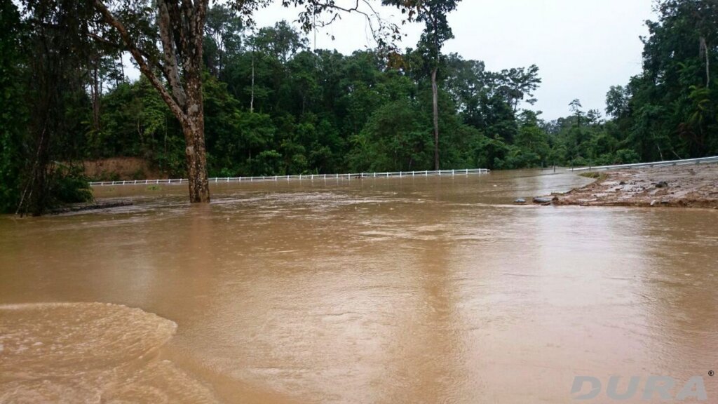The newly built bridge fully submerged in river water during the extreme flood event in Malaysia history