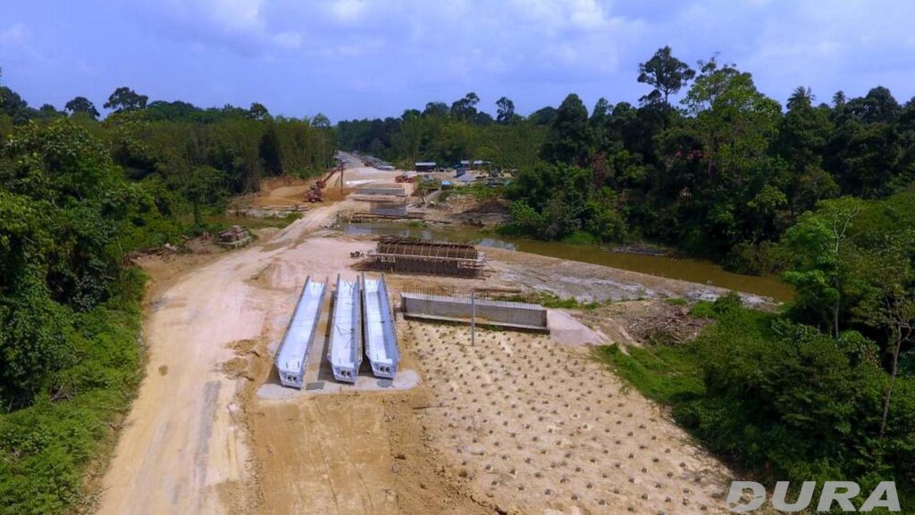 Three U-beams assembled behind the abutments.