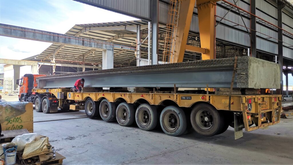 Transportation of precast UHPC beam-deck bridge.