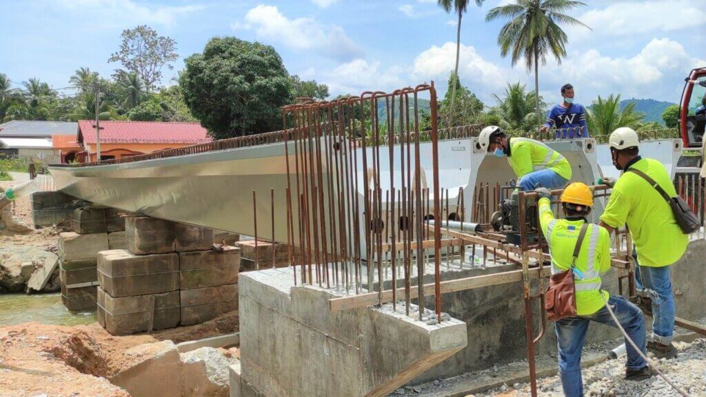 Pushing prestressed cable for first beam.