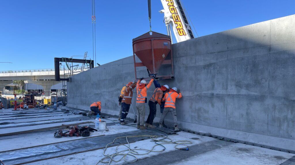Casting of UHPFRC using mobile crane and hopper method.