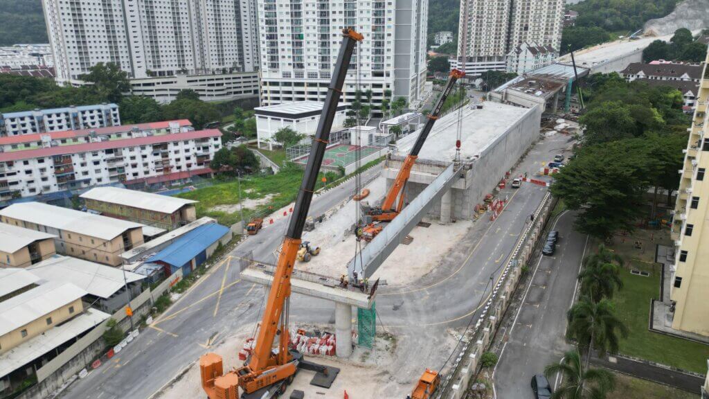 Heavy-duty mobile cranes mobilized on site in preparation for the erection of precast UHPC bridge girders onto the completed bridge piers and abutments.