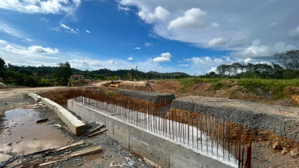 Bridge approach earthworks and reinforced concrete retaining wall construction.