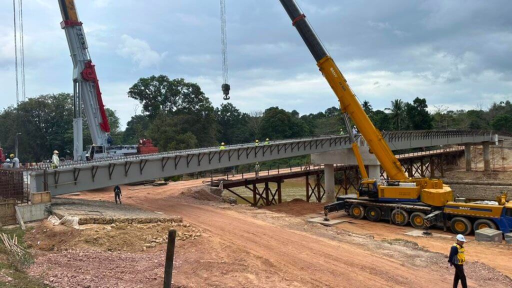 Beam positioned and seated on abutments.
