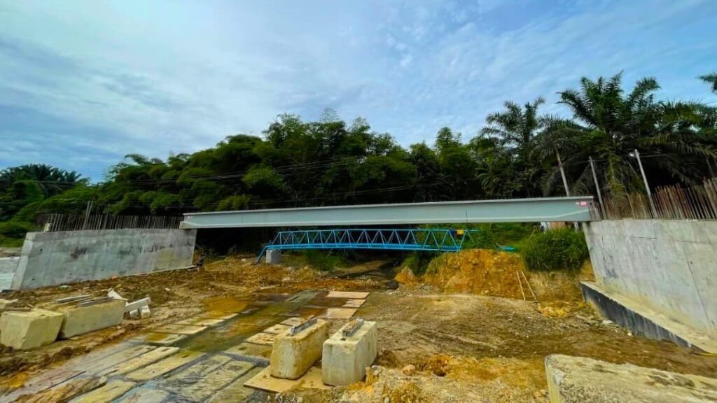 The first beam has been successfully positioned onto the abutments.