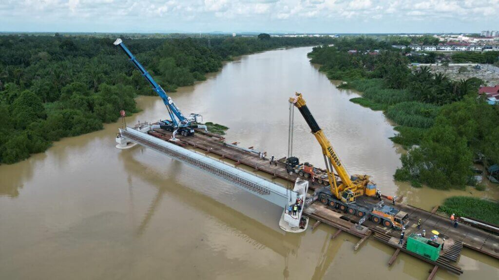 Beam launching works are in progress. The beam has been lifted and positioned across the bridge span, with final alignment and bearing placement currently underway.
